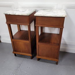 Pair of Antique French Oak Louis XVI style marble top bedside cabinets. They have decorative inlay and have been sourced from France. They are in good original detailed condition.