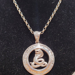 Sterling Silver pendant featuring a Cobra Snake with Cubic Zirconia surround. Heavy Bale with Cubic Zirconia. Pendant without Bale, 3.5cm Diameter. Includes 60 cm Sterling Silver Chain.
