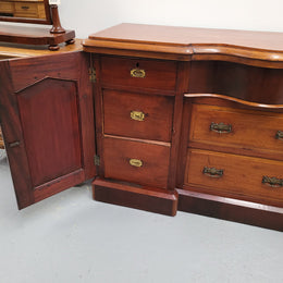 An English Victorian Mahogany sideboard with nine drawers. This amazing piece has loads of storage with three central drawers in the middle and a further six drawers. It has three each side located behind two doors. It has been sourced from locally and in original detailed condition.