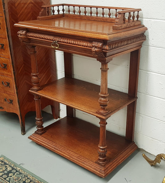 A French 19th century oak carved three tier cabinet. The cabinet/dumbwaiter has carved half border top that can be removed. Drawer for storage and in very good original condition.