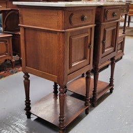 Antique French Oak Henry II white marble top bedside cabinets. They have one drawer and cupboard a long with an open shelf at the bottom. Sourced from France and in good original detailed condition.