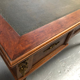 Lovely French Mahogany Louis XVI style leather top desk. With beautiful ormolu details and three drawers. There are also two slides on either side with tooled leather tops and in good original detailed condition.