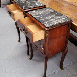 Appealing Louis XV style high quality bedside cabinets with black Portoro marble top and bronze mounts. They have been sourced from France and are in good original condition.