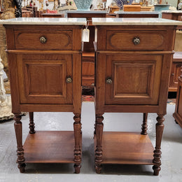 Antique French Oak Henry II white marble top bedside cabinets. They have one drawer and cupboard a long with an open shelf at the bottom. Sourced from France and in good original detailed condition.