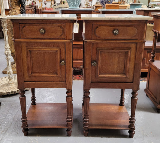 Antique French Oak Henry II white marble top bedside cabinets. They have one drawer and cupboard a long with an open shelf at the bottom. Sourced from France and in good original detailed condition.