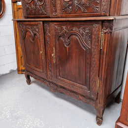 French Oak 18th Century superbly carved sideboard buffet. This amazing buffet has loads of character which is expected being circa 1790's. The top section has two fixed shelves and the bottom section has one fixed shelf. It has been sourced from France and is in good original detailed condition.