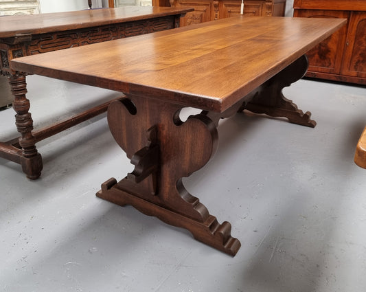 Solid French Oak Monastery sourced directly from France. This table comfortably sits 6-8 people and features a stunning top that is supported on a large trestle base, and united with a single stretcher secured at each end with oak pegs. in good original detailed condition.