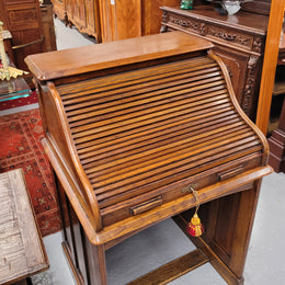 Charming petite English Oak fitted roll top desk. It has a very lovely fitted interior and a drawer at the front ideal for a unit or apartment. Sourced locally and in good original detailed condition.