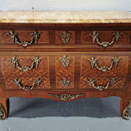 A beautifully inlaid parquetry three drawer commode with a lovely marble top, and decorative ormolu mounts. In good original detailed condition. Circa 1930