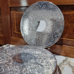 Five Strachan and two Rodd silver plate table coasters in a silver plate stand. In good original detailed condition.