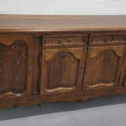 Late 19th Century French carved Oak Louis XV style four drawer sideboard. Plenty of storage space with four cupboards and two drawers. It is in good original detailed condition with all locks functioning with keys.