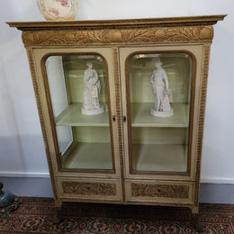 19th Century painted and gilt two door vitrine. Has one adjustable shelf and two drawers. In good original detailed condition.