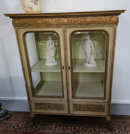19th Century painted and gilt two door vitrine. Has one adjustable shelf and two drawers. In good original detailed condition.
