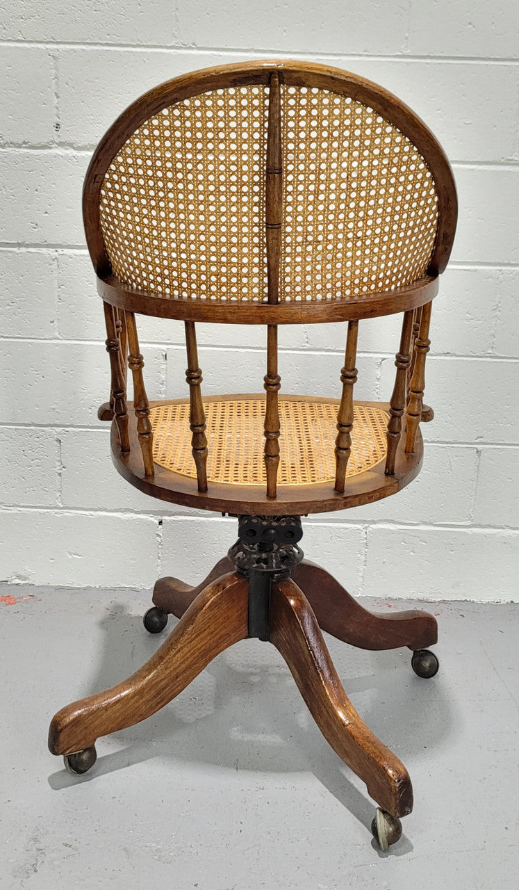 Elm Bentwood and cane swivel desk chair. In good original detailed condition and is comfortable to sit in.