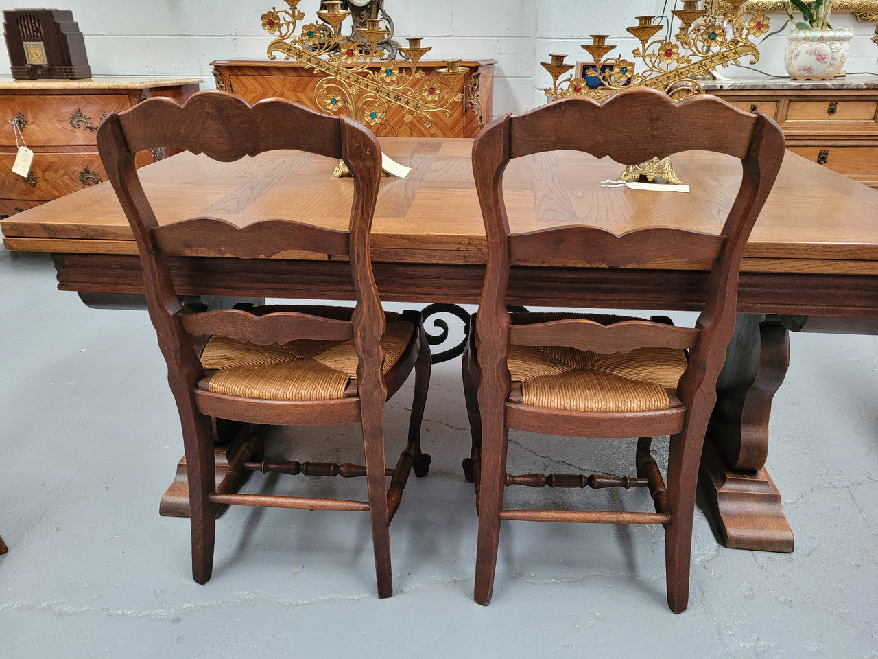 Set of six Louis XV style French Oak rush seat dining chairs. These chairs are very sturdy and have been professionally re-glued to ensure long lasting strength and sturdiness. They are in very good original detailed condition.