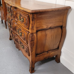 French Antique Louis XIV style Oak wooden top commode. It has a stunning serpentine bombe shape front along with amazing handles and carvings. It comes with three beautiful keys as pictured and comes with working locks. It has been sourced from France and in good original detailed condition.