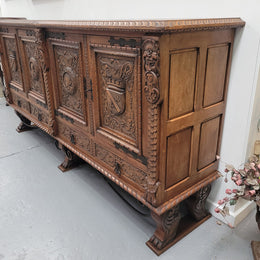 Large French Oak Renaissance style four door sideboard/buffet. Great decorative item with amazing carvings and stunning iron work on base. It is in good original detailed condition. Can pull apart completely making it easier to move.