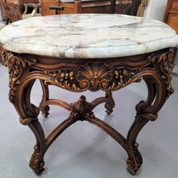French Walnut Louis XV style round marble top centre table. It has amazing eye-catching marble, ornate detailed carvings and a beautifully carved undercarriage. In good original detailed condition.