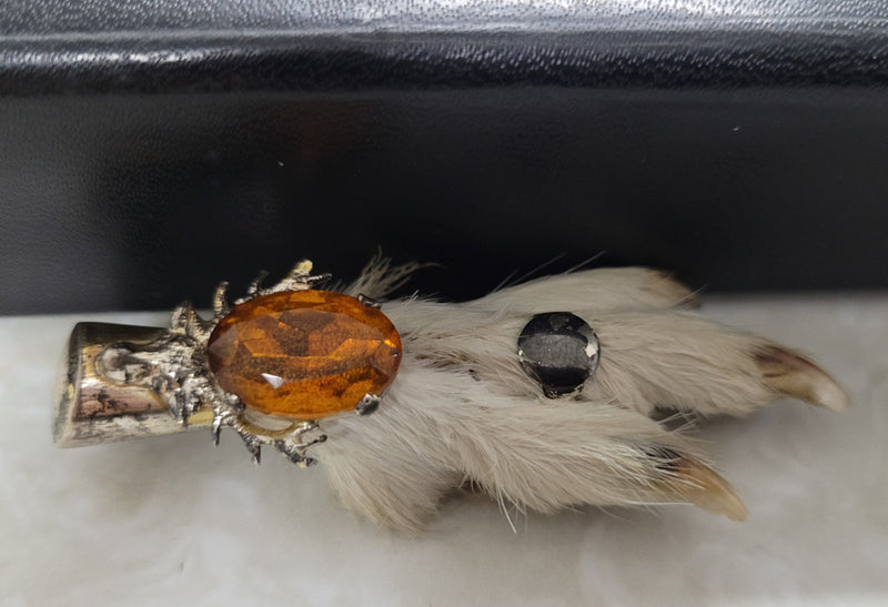 Scottish Grouse foot with Amber coloured glass. In good original condition, please view photos as they help form part of the description.