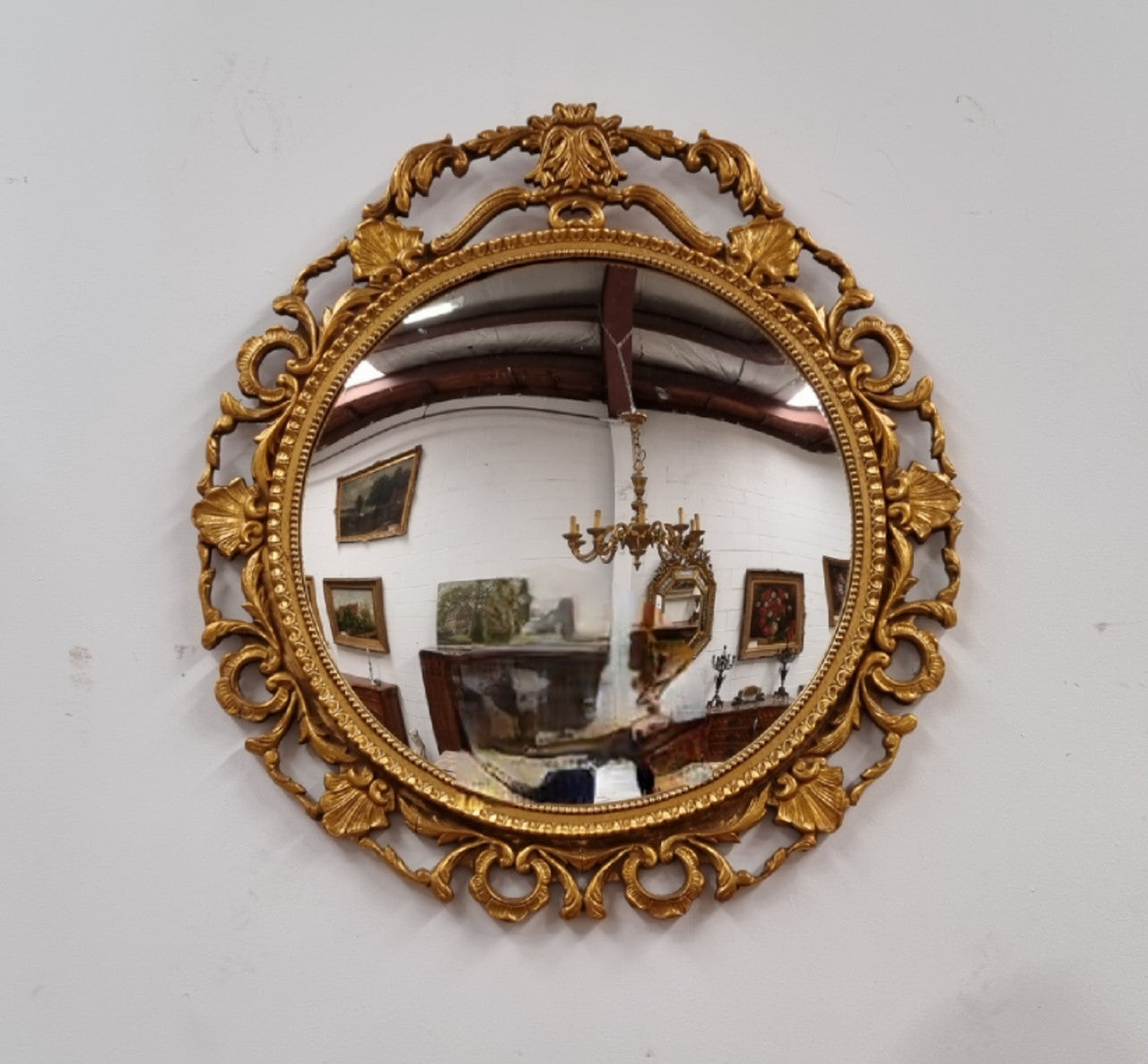 Vintage large round ornate convex mirror. Lovely gilt decoration around and is in good original condition.