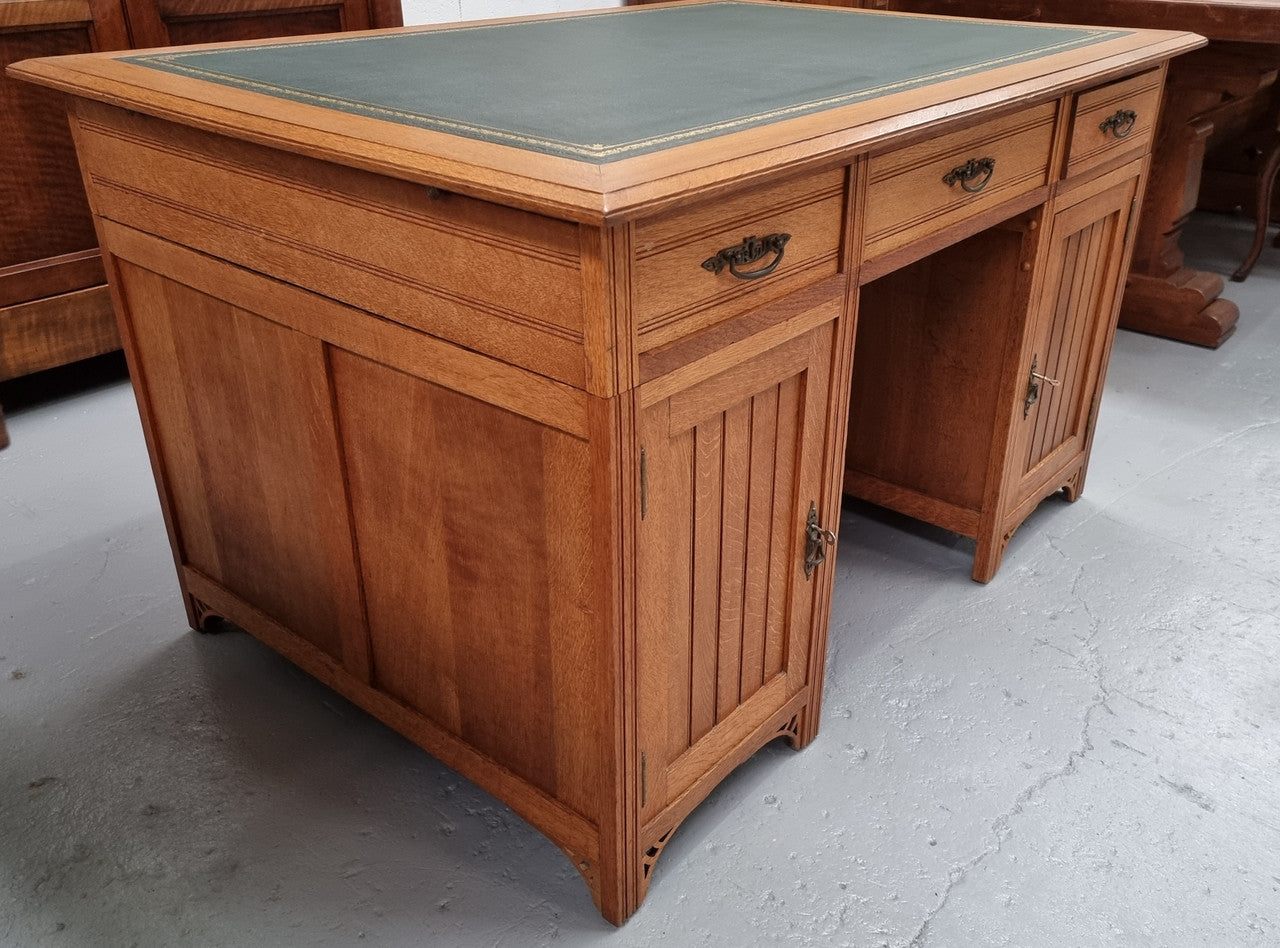 French Oak Art Deco full partners desk with leather top. Plenty of storage with both sides having three drawers at the top and two cupboards on both sides, one side has a filing section with three internal drawers and the other has a shelf on one side with three internal drawers as well. In good original detailed condition.