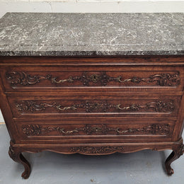 French Oak Louis XV style marble top chest of three drawers. It has beautiful carvings on the drawers with lovely decorative handles all toped with a stunning black and white marble top. In good original detailed condition.