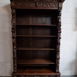 Amazing dark Oak heavily carved Gothic style bookcase with lovely details and adjustable shelves in good original detailed condition. The doors currently have no glass which can easily be added or be left  with open shelves.