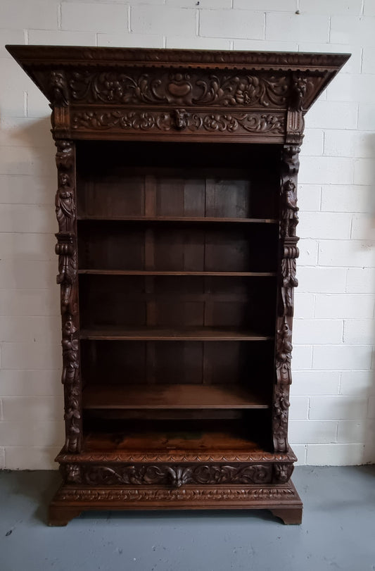 Amazing dark Oak heavily carved Gothic style bookcase with lovely details and adjustable shelves in good original detailed condition. The doors currently have no glass which can easily be added or be left  with open shelves.