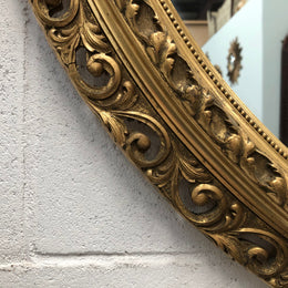 Decorative round gilt wall mirror.