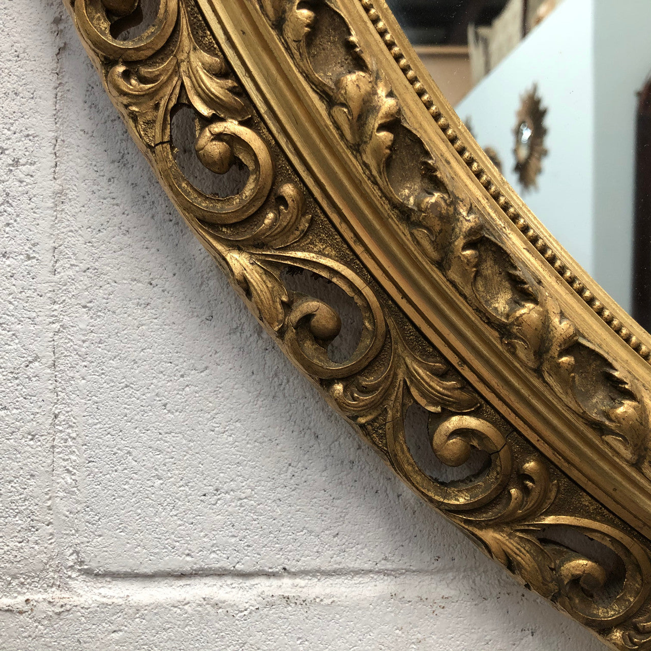Decorative round gilt wall mirror.