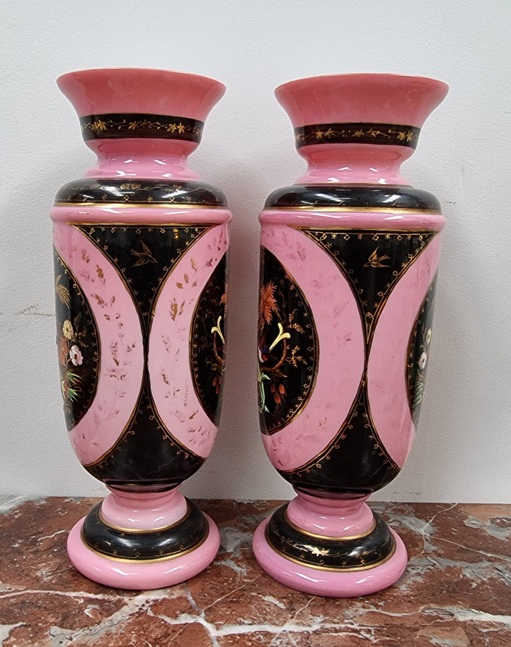 Late Victorian pink and hand painted, enameled pair of vases with some ware to enameling. It is in good original condition.