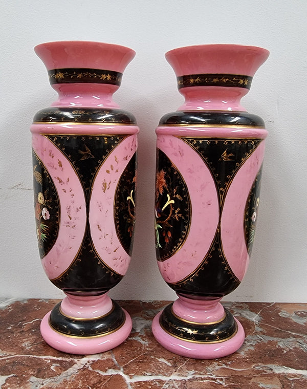 Late Victorian pink and hand painted, enameled pair of vases with some ware to enameling. It is in good original condition.