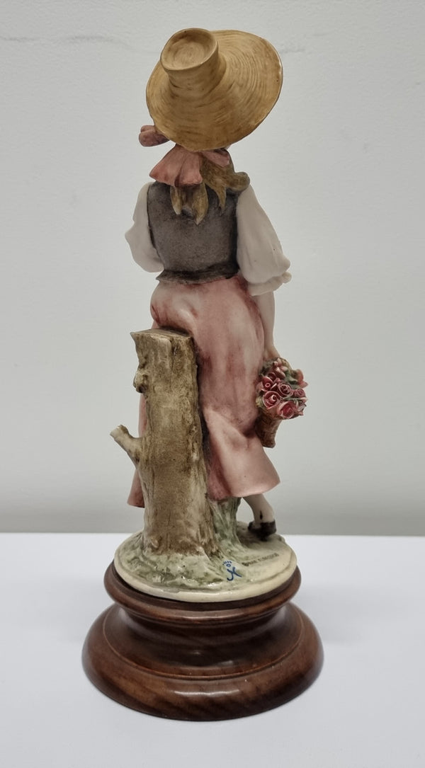 Lovely Italian figurine of girl carrying basket with flowers, figurine is on a wooden base. It is signed Giuseppe Armani and 1982 FLORENCE. In good original condition.  Please view photos as they form part of the description.