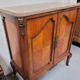 Stunning compact Louis 15th style two door walnut cabinet with ormolu trim and marble top. It is in good original condition.
