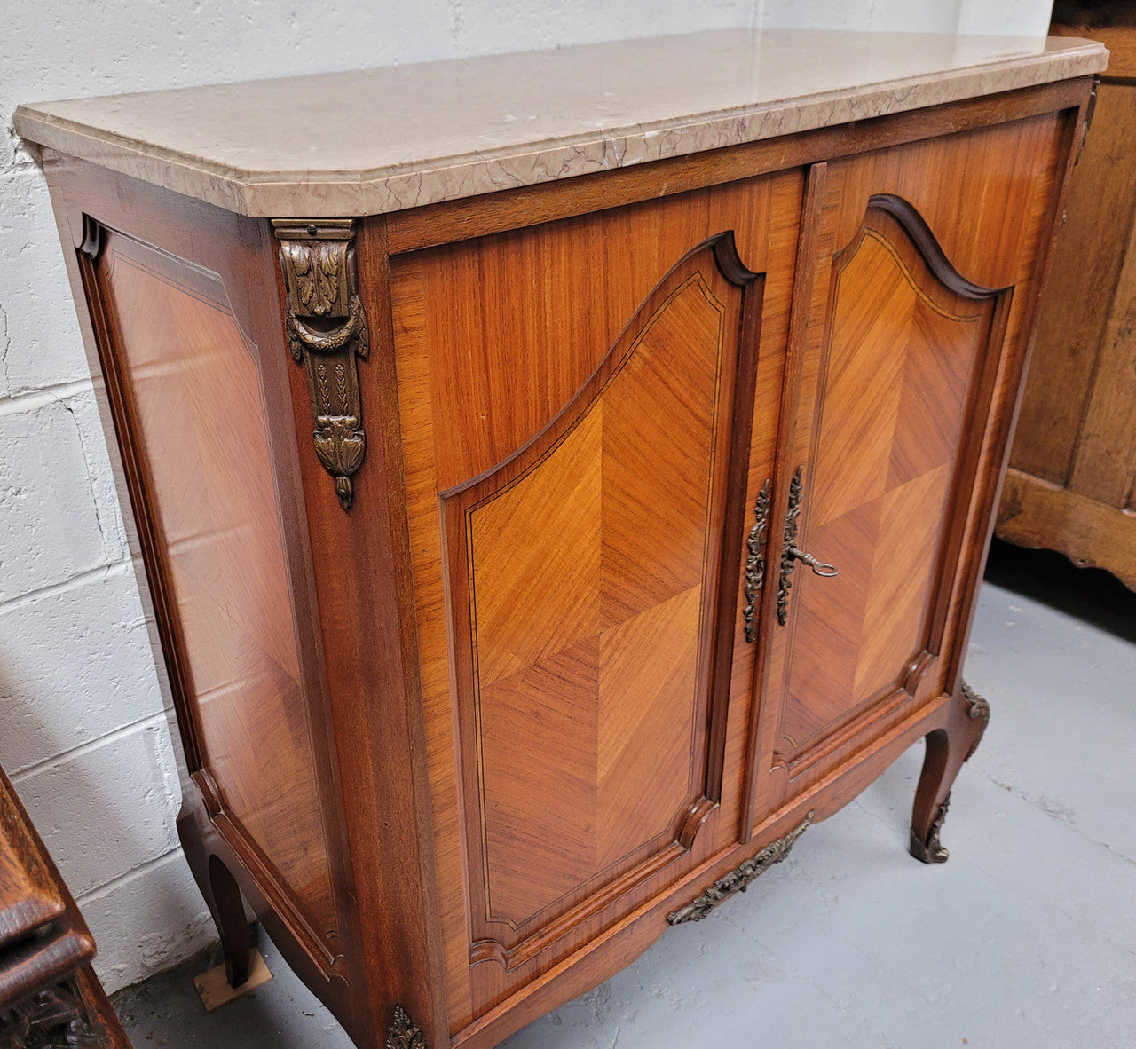 Stunning compact Louis 15th style two door walnut cabinet with ormolu trim and marble top. It is in good original condition.