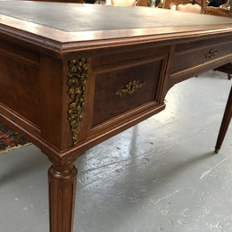 Lovely French Mahogany Louis XVI style leather top desk. With beautiful ormolu details and three drawers. There are also two slides on either side with tooled leather tops and in good original detailed condition.