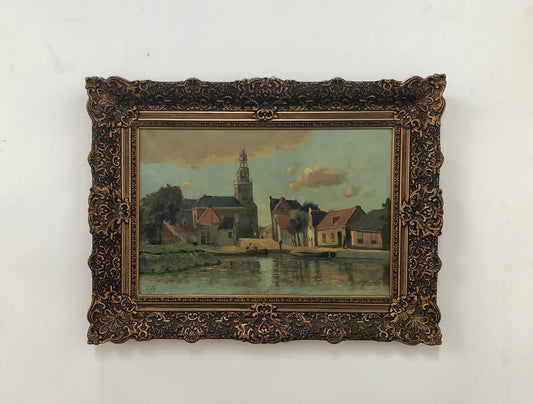 Sourced in France is this lovely oil on canvas town and river scene in a beautiful ornate frame. In good condition.