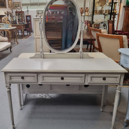 French Louis XVI style painted dresser / console with beveled oval mirror and three drawers. Sourced from France and in good original detailed condition.