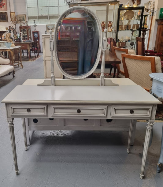 French Louis XVI style painted dresser / console with beveled oval mirror and three drawers. Sourced from France and in good original detailed condition.