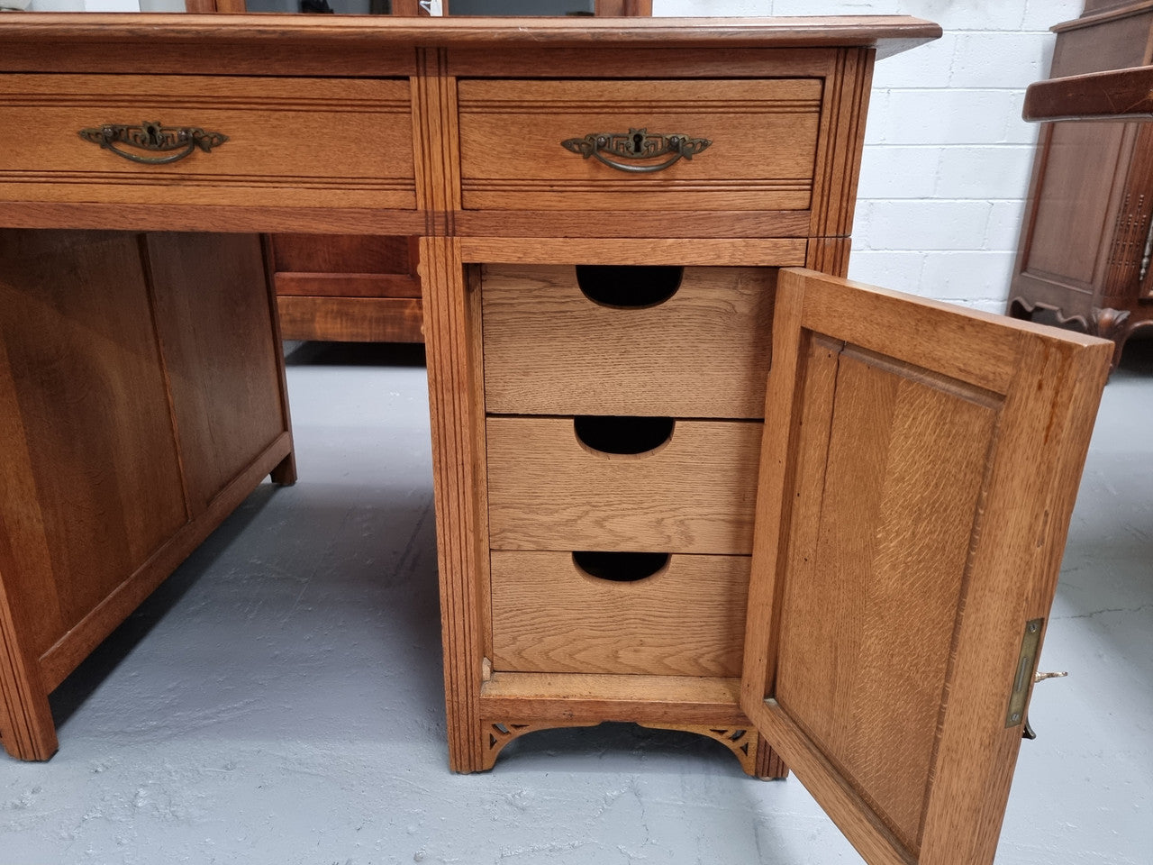 French Oak Art Deco full partners desk with leather top. Plenty of storage with both sides having three drawers at the top and two cupboards on both sides, one side has a filing section with three internal drawers and the other has a shelf on one side with three internal drawers as well. In good original detailed condition.