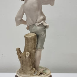 Lovely Italian figurine of boy carrying basket with grapes on a wooden base. It is signed Giuseppe Armani and 1982 FLORENCE. In good original condition.  Please view photos as they form part of the description.