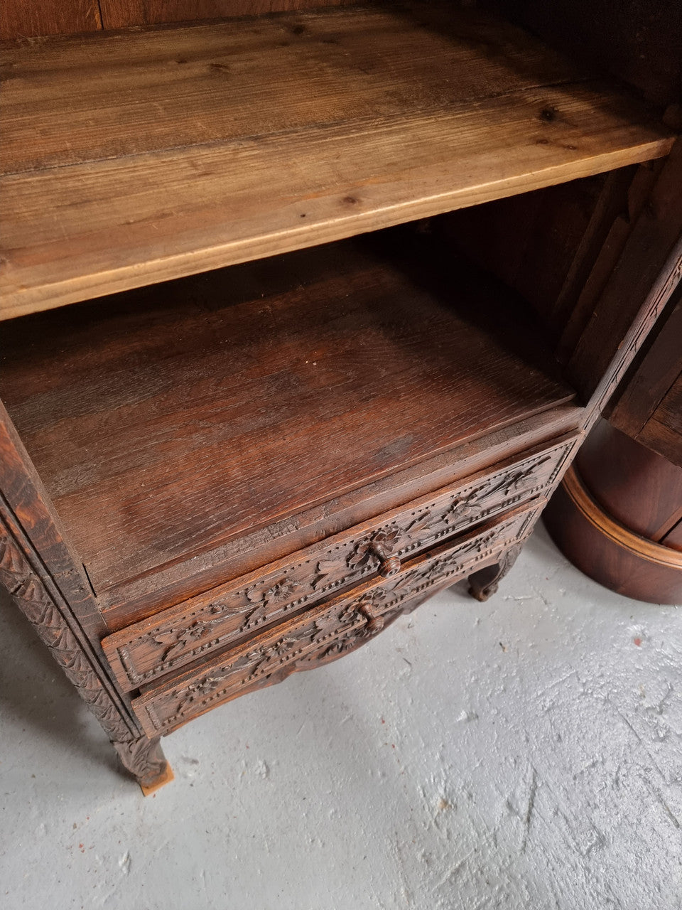 Petite oak armoire display cabinet with a glass door, two drawers at the bottom and three shelves inside. Late 18th Century and amazing detailed decorative carvings. Sourced from France and in good original condition.