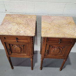 Pair of Louis XV French Oak and marble top bedside cabinets. They have beautiful detailed carving and stunning color marble top. They are in very good original detailed condition.