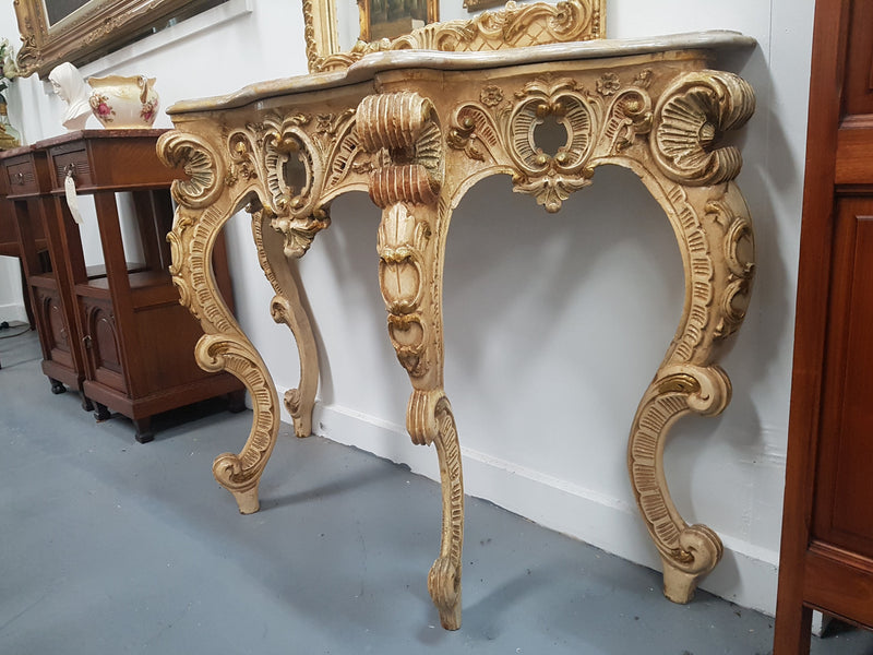 Beautifully carved Italian Rococo style painted console/hall table and mirror. An amazing coloured marble top showing sections of gold veins and is in good condition. Mantle mirror is retaining it's original mirror and showing ages spots.