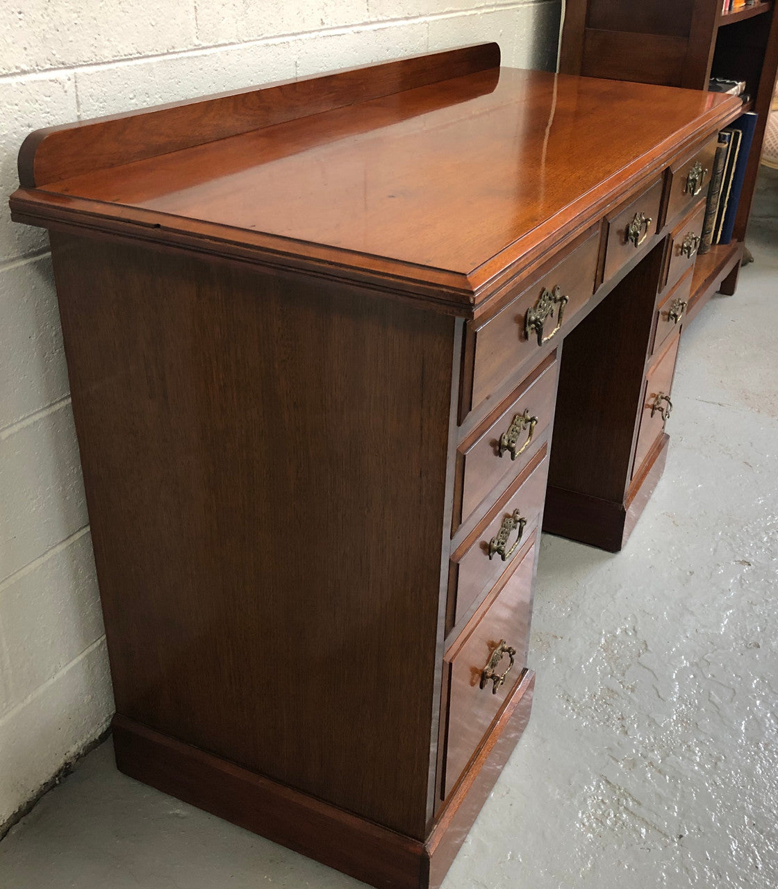 Fabulous small size walnut desk, with nine drawers and decorative brass handles and in good original condition.