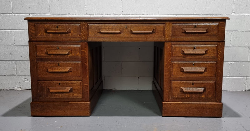 Amazing American Oak full partners leather top desk. Plenty of storage space with nine drawers on one side and two cupboards of the oppsite side. It is in good restored condition and has a new leather and gold tooled inset top.