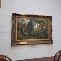 Large signed oil on canvas depicting a river stream in autumn framed in a stunning gilt frame. Sourced from France and is in good original detailed condition.
