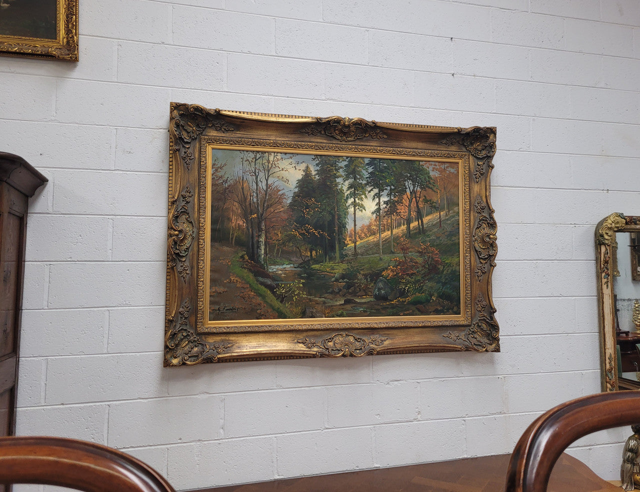 Large signed oil on canvas depicting a river stream in autumn framed in a stunning gilt frame. Sourced from France and is in good original detailed condition.