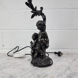 Antique French bronzed metal lamp with cherub's. in very good working original detailed condition.