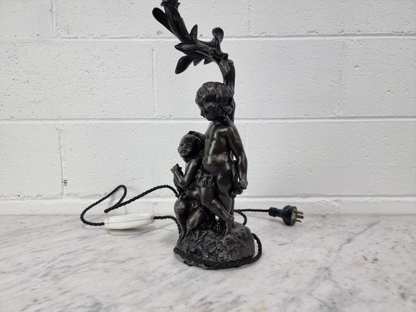 Antique French bronzed metal lamp with cherub's. in very good working original detailed condition.